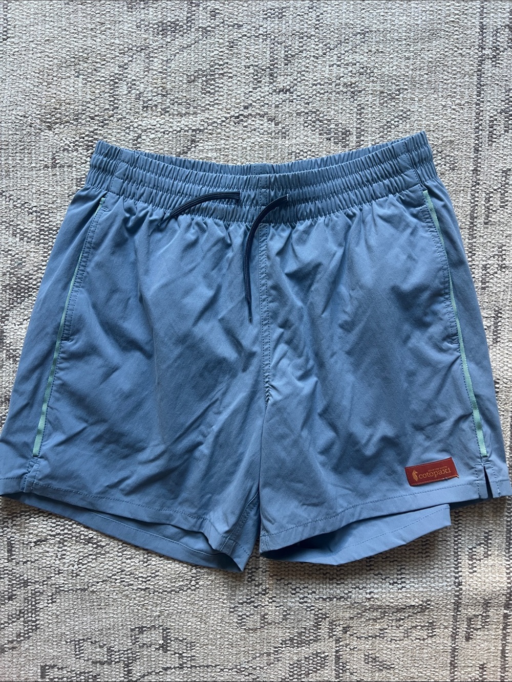 cotopaxi Brinco 5” light blue athletic shorts with mint accents